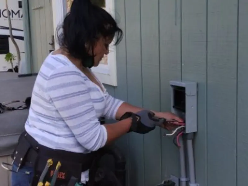 Licensed electrician wiring an exterior subpanel in Destrehan