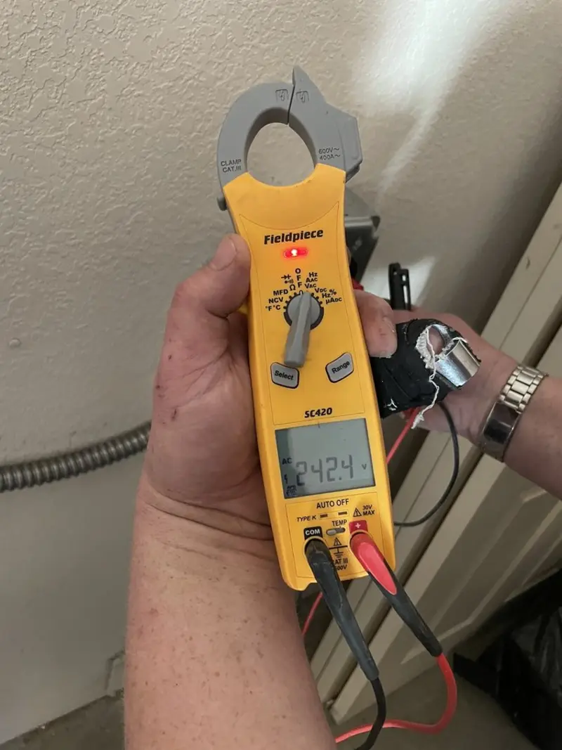 Voltage testing with clamp meter during Ceiling Fan Installation in Destrehan